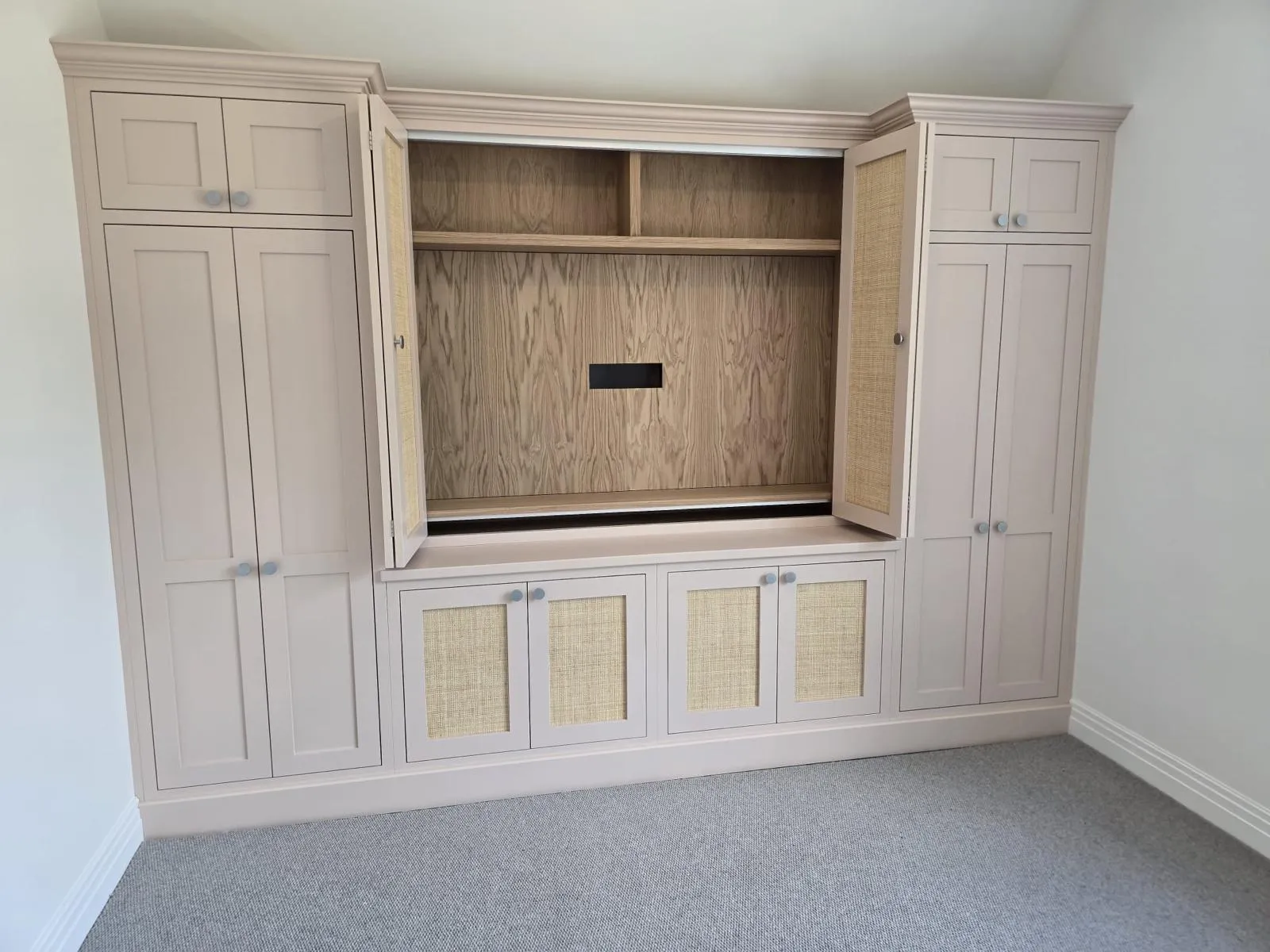 A white entertainment center with a built in entertainment center.